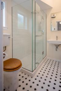 阿卡罗阿法国湾旅馆的一间带卫生间和玻璃淋浴间的浴室