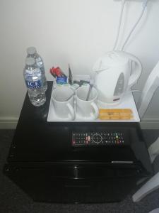 梅瑟蒂德菲尔The Antelope Hotel的桌子,盘子上装有杯子和一瓶水