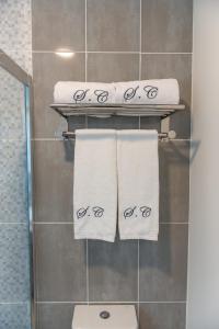 明德卢Santa Cruz Boutique Hotel的浴室提供毛巾架上的白色毛巾