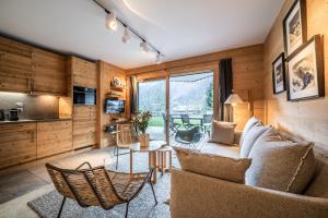 里雾诗Apartment Valvisons Les Houches Chamonix - by EMERALD STAY的客厅配有沙发和桌子