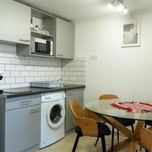 沙罗什保陶克Fakapu Vendégház的厨房配有洗衣机和桌椅