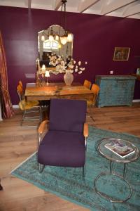 彼得比伦Wonderland的一间带桌子和紫色椅子的用餐室