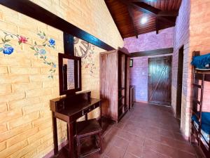 巴尼奥斯Hostería EL Trapiche Lodge & Spa的走廊上设有桌子,墙上挂着壁画