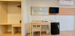 卡伦海滩Karon Living Room - SHA Plus的厨房配有桌子和带冰箱的书桌