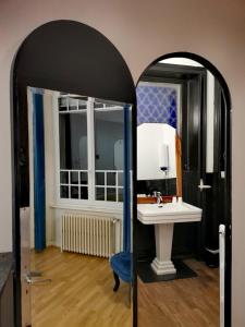 圣瑞尼安Chambres d'hôtes La Maison Blanche的一间带水槽和镜子的浴室