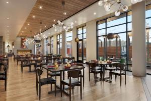 高尔顿Origin Red Rocks, a Wyndham Hotel的餐厅设有桌椅和窗户。