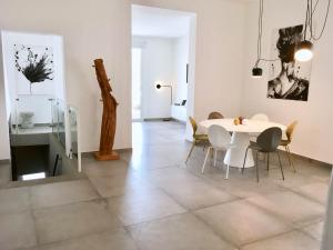卡塔尼亚Sunshine Luxury Apartment - Ognina Catania的一间配备有白色桌椅的用餐室