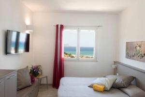 卡斯泰拉马莱La Blanca Resort & Spa的一间卧室设有一张床和一个海景窗户
