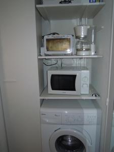 米尼赞海滩A Deux Pas du Courant的厨房配有微波炉和洗衣机。