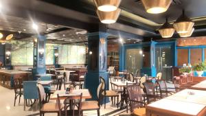 巨港Luminor Hotel Palembang by WH的用餐室配有桌椅和灯光