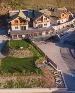 安达洛La Dila Dolomiti Mountain Lodge的享有大房子空中美景,设有庭院