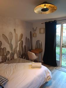 索恩河畔沙隆Le Nid Bourguignon的卧室墙上挂着仙人掌壁画