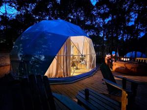 Boiling SpringsBroad River Campground Cabins & Domes的甲板上的大型圆顶帐篷
