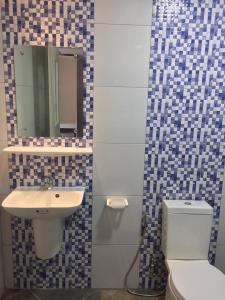 波尔多·格尼拉Answer hotel的一间带卫生间、水槽和镜子的浴室