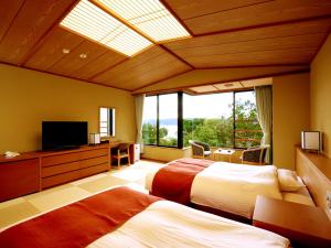 宫古市海滨净土公园酒店的一间卧室设有两张床和大窗户