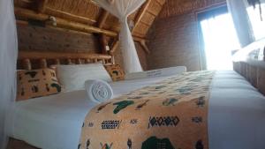 WansekoNKUNDWA NILE VIEW LODGE的卧室配有一张白色的床,床上有毯子