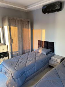 Ash ShāghūrVilla Jana chalet - Private Villa - Dead Sea - Jordan的一间卧室配有两张床和一张大床,铺有四柱床。