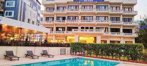 瑞诗凯诗Hotel Dewa Retreat- A Himalayan Boutique Hotel的大楼前设有游泳池的酒店