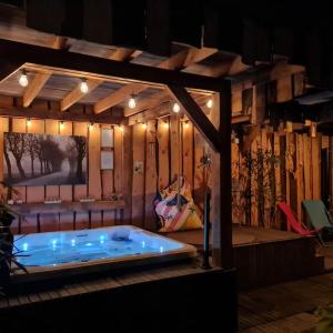 圣安娜兰wellness chalet met jacuzzi, sauna, omheinde tuin,的木墙客房内的热水浴缸
