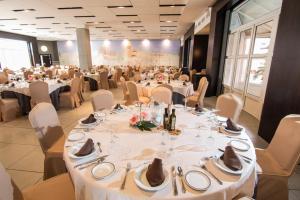 洛哈Hotel Abades Loja的宴会厅配有白色的桌椅
