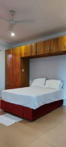 霍尼亚拉Marine Apartments的一间卧室配有一张带木制橱柜的大床