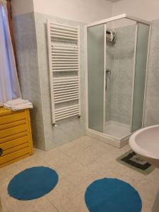 库马约尔Villa Tancredi的带淋浴、水槽和蓝色地毯的浴室