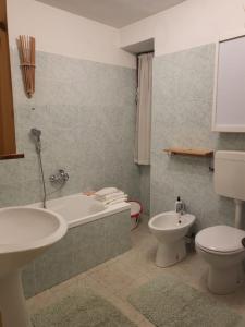 库马约尔Villa Tancredi的带浴缸、卫生间和盥洗盆的浴室
