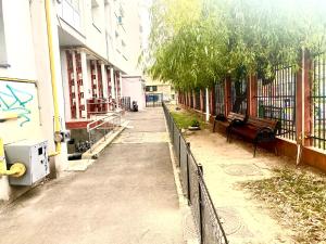 布加勒斯特CASA DIEGO的一条有栅栏和长凳的街道,毗邻一座建筑