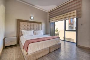 塔哈佐特Medina Bay Taghazout 4 or 5 PX Luxe的一间卧室设有一张大床和一个大窗户