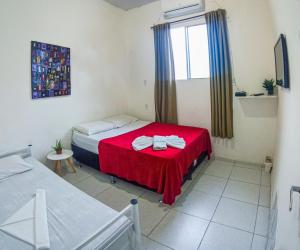 福塔莱萨Hostel Dragão do Mar Fortaleza的小房间设有两张床和窗户