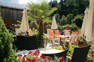 萨尔巴赫艾德米卡拉酒店的一个带桌椅和遮阳伞的庭院