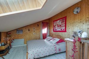EnchastrayesL'Edelweiss - Au pied des pistes的一间卧室设有一张床和木墙