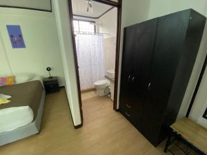 托尔图格罗Aracari Garden Hostel的浴室设有位于厕所旁的黑色橱柜