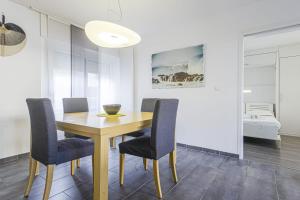 比亚里茨Nice flat with terrace and parking - Biarritz - Welkeys的一间带木桌和椅子的用餐室