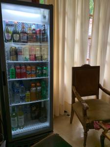 罗萨里奥SOLES Hostel Boutique的装满大量饮料的冰箱和椅子