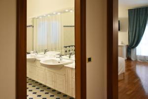 泰塞拉Venicegreen Agriresort的一间带两个盥洗盆和大镜子的浴室