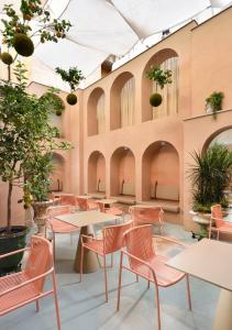 罗马罗马里昂宫酒店的配有桌椅和植物的房间