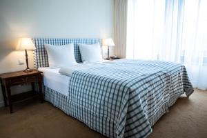 班贝格Altstadthotel Messerschmitt的一间卧室配有一张带蓝白色毯子的床