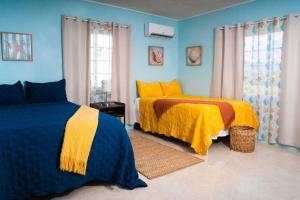 特雷热比奇Treasured Gem Hideaway的一间卧室设有两张黄色和蓝色的床
