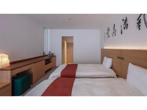 奈良Hotel Tenpyo Naramachi - Vacation STAY 59515v的一间卧室配有两张床和一张带台灯的桌子