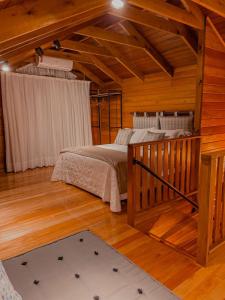加斯帕Pousada e Restaurante Casa Cida e Evandro的木屋内设有一间带两张床的卧室