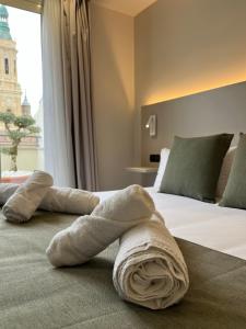 萨拉戈萨AZ Hotel San Valero的铺在酒店客房床上的毛巾