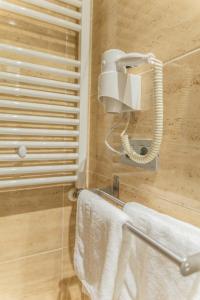 桑托多明戈德锡洛斯Apartamentos & casas rurales Santo Domingo de Silos的一间带毛巾架和电话的浴室