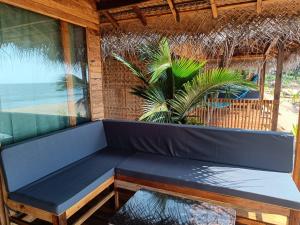 卡纳科纳Bamboo Yoga Retreat的棕榈树间的一个蓝色长椅