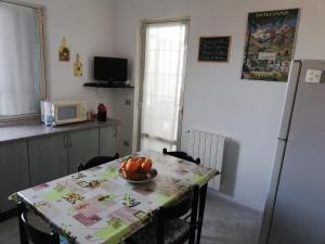 奥里斯塔诺Casa Marcy的厨房配有一张桌子,上面放着一碗水果
