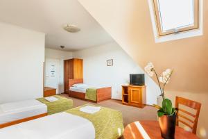 布达佩斯布达佩斯巴罗斯城市酒店的酒店客房设有两张床和一张桌子。