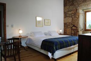 科维良金塔德斯非酒店的一间卧室配有一张床和一张桌子及椅子