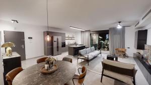 海法Luxury 3&4 Bedroom new apartments - close to the Beach & Bahai Gardens的客厅配有桌子和沙发