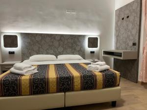 罗马Hotel principe的一间卧室配有一张大床和毛巾