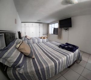 阿雷基帕Departamento amplio y bonito en Arequipa 1er Piso的一间卧室配有两张床和一台平面电视